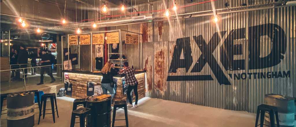People standing at a bar decorated with industrial-style fittings